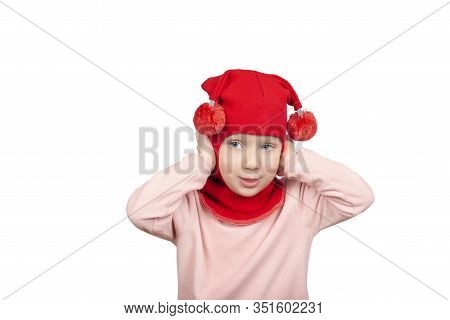 Funny Little Girl In Red Wool Winter Balaclava Or Knitted Cap Making Funny Faces. Gigl Closing Her E