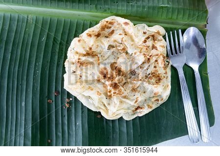 Overhead View Of Roti Canai Or Paratha On Banana Leaf, Favourite Malaysian Food