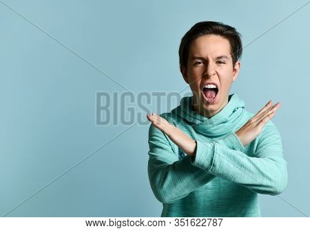 Young Teen Boy In Blue Hoodie Standing, Shouting And Asking Not To Do Something With Hands Over Past