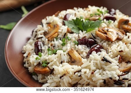 Delicious Rice Pilaf With Mushrooms And Beans In Plate, Closeup