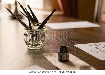 Antique Feather Pens, Old Letters, Vintage Postcards And Ink At The Wooden Table. Retro Nostalgic Se