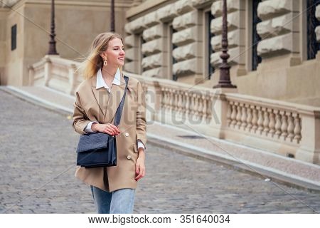Outdoor Portrait Of Young Beautiful Fashionable Woman Wearing Trendy Jacket With Small Shoulder Bag,