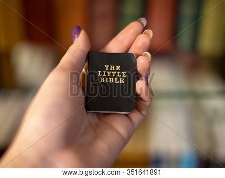 Little Holy Bible Book In Girls Hand.