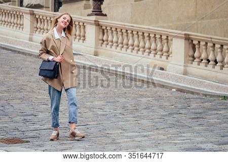 Outdoor Portrait Of Young Beautiful Fashionable Woman Wearing Trendy Jacket With Small Shoulder Bag,