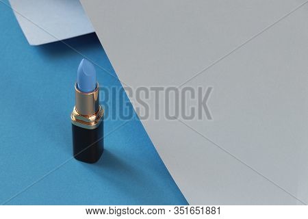 Blue Lipstick, Grey, Blue Background. Beautiful Blue Lipstick On A Blue Background With Grey Rolled-