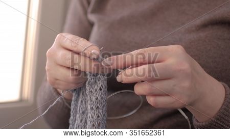 Close-up Of Hands Knitting. A Woman Knits A Sweater