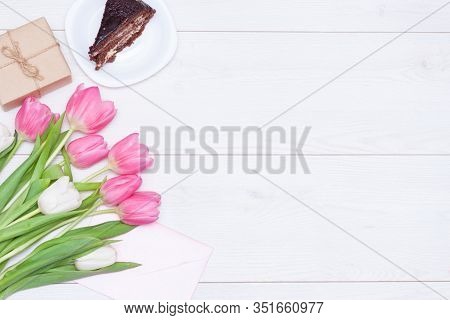 Bouquet Of Pink Tulips, Chocolate Cake. Pressent Box On White Wooden Background. Copy Space, Close U