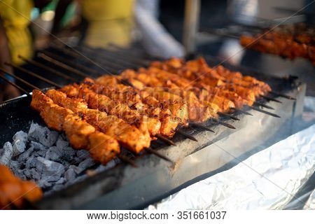 Paneer Fish Chicken Tikka Roasting On An Open Hearth With Glowing Coals And Smoke Coming Out