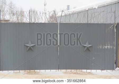 Dark Gray Walls Decorated With A Five-pointed Star And Barbed Wire. Stock Photo For Web And Print Wi