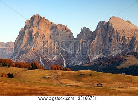 Autumn sunrise scenery with yellow larches in Alpe di Siusi (Seiser Alm) Dolomites, Italy, Europe