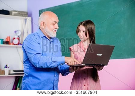 Teacher Help Schoolgirl. Little Girl With Man Tutor Study Hold Laptop. Pedagogue Of Digital Science.