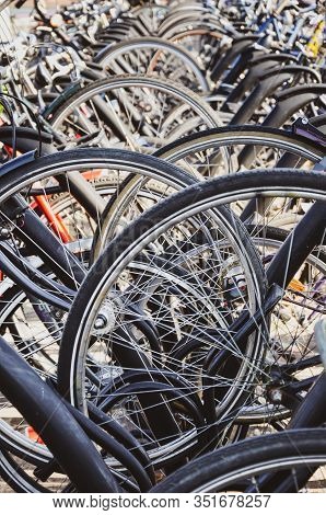 Detail Of The Bike Wheels Parked In Venlo, Limburg, Netherlands. Close Up Vertical Photo. Dutch Bicy
