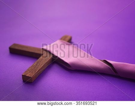 Good Friday, Lent Season And Holy Week Concept - A Christian Cross  On Purple Background.