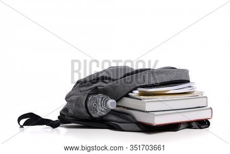 School backpack on a white background with books and spiral notebooks