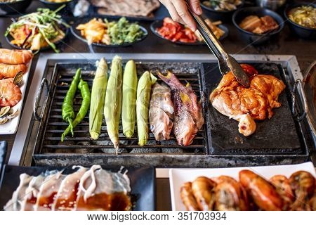 Bbq Chicken And Seefood  On Grill At Restaurant