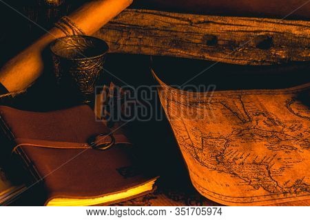 Old Plans Next To Other Elements In The Light Of Candles In Rustic Wood