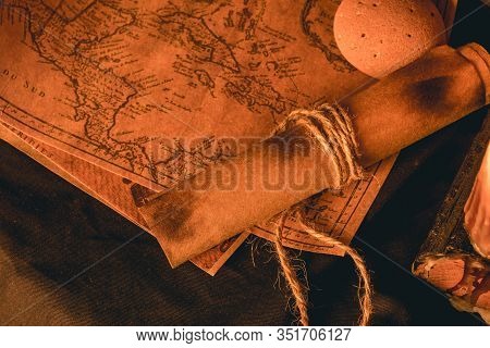 Old Plans Next To Other Elements In The Light Of Candles In Rustic Wood