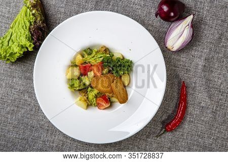 Salad With Black Sea Rapan Meat, Dressed With Honey Sauce. With Rye Crackers. On A Gray Canvas Cloth