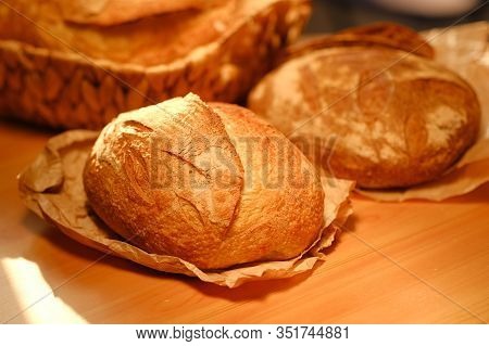 Different Buns Of Fresh Bread On A Brown Vintage Background. Freshly Baked Wheat Bread, Still Life W