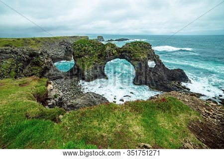 Amazing Seascape, Gatklettur Basalt Rock Arch At The Volcanic Cliff, Atlantic Coast Of Arnarstapi In