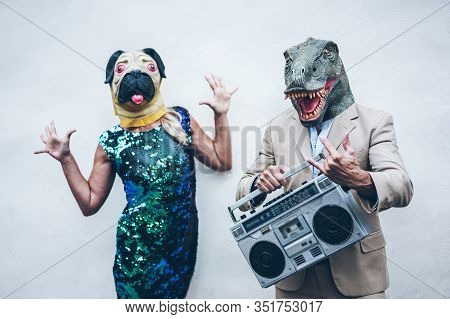 Crazy Senior Couple Dancing For Party Wearing T-rex And Chicken Mask - Old Trendy People Having Fun 