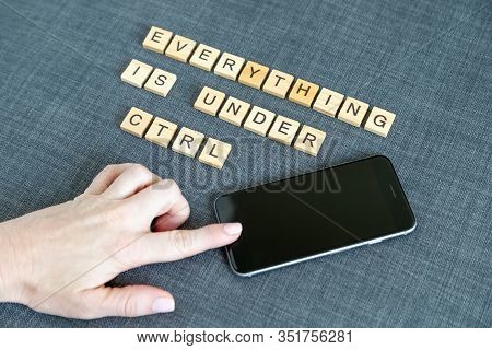 Everything Is Under Control, Flat Lay Message From Wooden Blocks And Hand On Mobile Phone