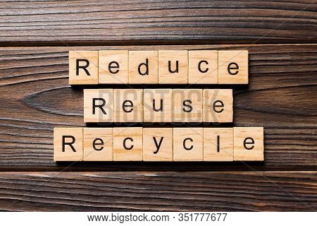 Reduce, Reuse And Recycle Word Written On Wood Block. Reduce, Reuse And Recycle Text On Wooden Table