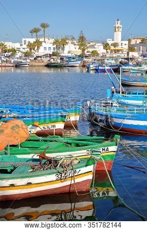 Mahdia, Tunisia - December 27, 2019: The Fishing Port With Colorful Fishing Boats And The City Of Ma