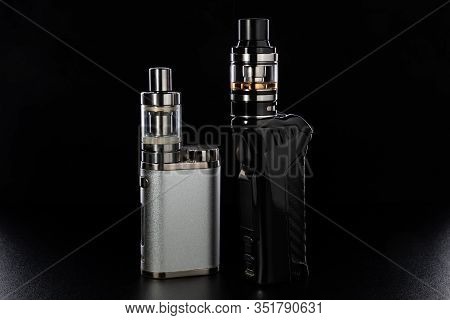 Electronic Cigarettes Or Vaping Devices On Black Background