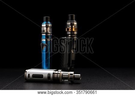 Electronic Cigarettes Or Vaping Devices On Black Background