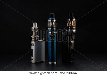 Electronic Cigarettes Or Vaping Devices On Black Background
