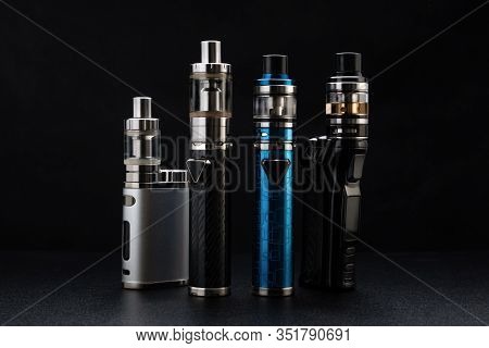 Electronic Cigarettes Or Vaping Devices On Black Background