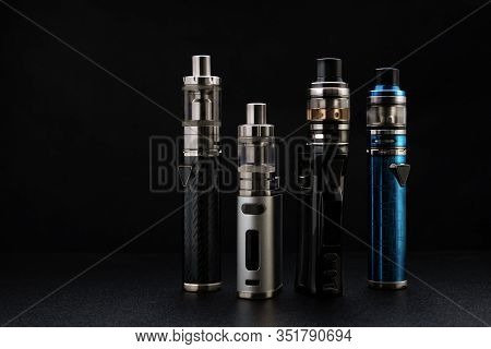 Electronic Cigarettes Or Vaping Devices On Black Background