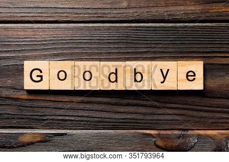 Goodbye Word Written On Wood Block. Goodbye Text On Table, Concept