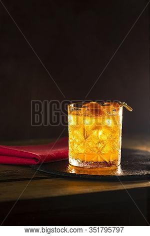 Glass Of The Cocktail Negroni On A Old Wooden Board. Drink With Gin, Campari Martini Rosso And Orang