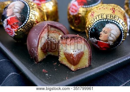 Tambov, Russian Federation - February 14, 2020 Mozart Candies On Black Plate.  One Candy Is Open And