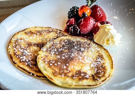 Pancake With Icing Sugar With Strawberry And Blueberrry Compote And Fresh Cream