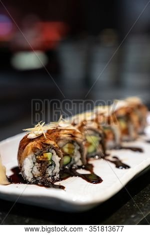 Traditional japanese food cuisine Unagi roll, japanese ell serve with japanese rice and avocado with special sauce.