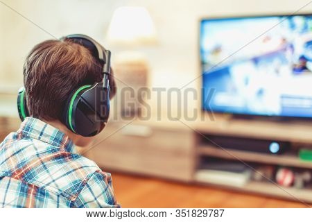 Young Kid Playing Mass Multiplayer Game Online, Back View