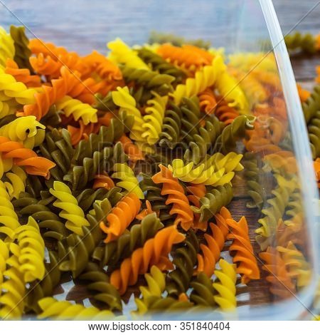 Composition Of Raw Pasta Uncooked Tricolore Fusilli, Pasta Twist Shape. Close Up And Selective Focus