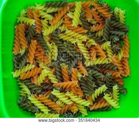 Composition Of Raw Pasta Uncooked Tricolore Fusilli, Pasta Twist Shape. Close Up And Selective Focus