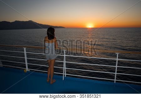 Asian Teen In Tube Top Standing On Deck Of Ferry Looking At Sunset On Ferry To Lesvos