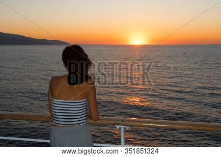 Asian Teen In Tube Top Standing On Deck Of Ferry Looking At Sunset On Ferry To Lesvos