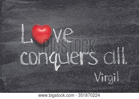 Love Conquers All - Quote Of Ancient Roman Poet Virgil Written On Chalkboard With Red Heart Symbol