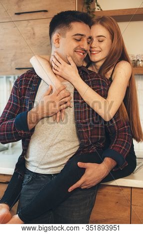 Lovely Caucasian Girl With Red Hair And Freckles Embracing Her Lover While Standing On The Table In 