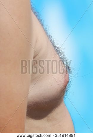 Big Breasts In Men On A Blue Background.