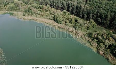 Large Lake On A Cloudy Day Against The Background Of A Dense Green Forest, Nature In Russia