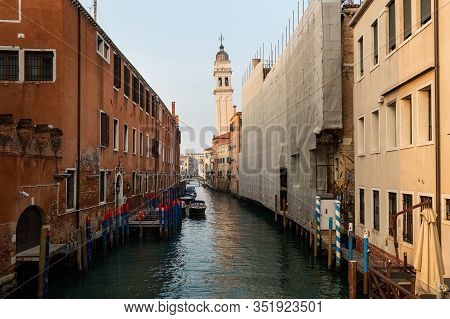 Venice, Italy - 02 05 2020: Canal With Boats In Venice (italy) In Winter, Leaning Bell Tower Of San 