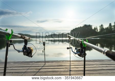 Carp Fishing On Beautiful Blue Lake With Carp Rods And Rod Pods In The Summer Morning. Fishing From 