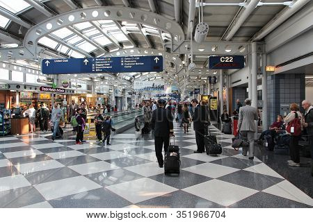 Chicago, Usa - April 1, 2014: Pilots Walk To Gate At Chicago O'hare International Airport In Usa. It